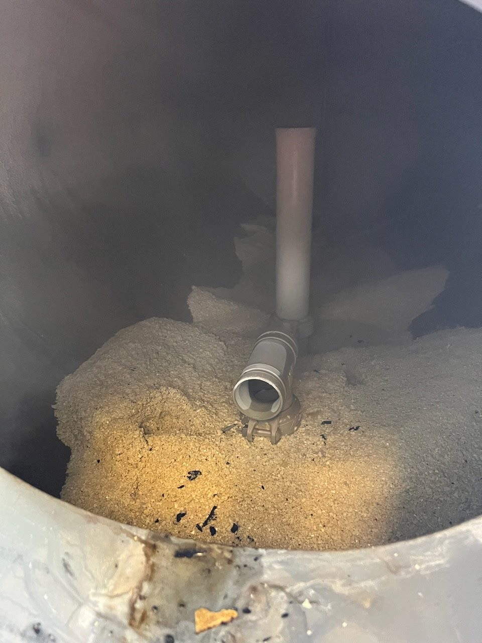 Interior of a commercial boiler in Austin caked with calcium sulfate scale before treatment